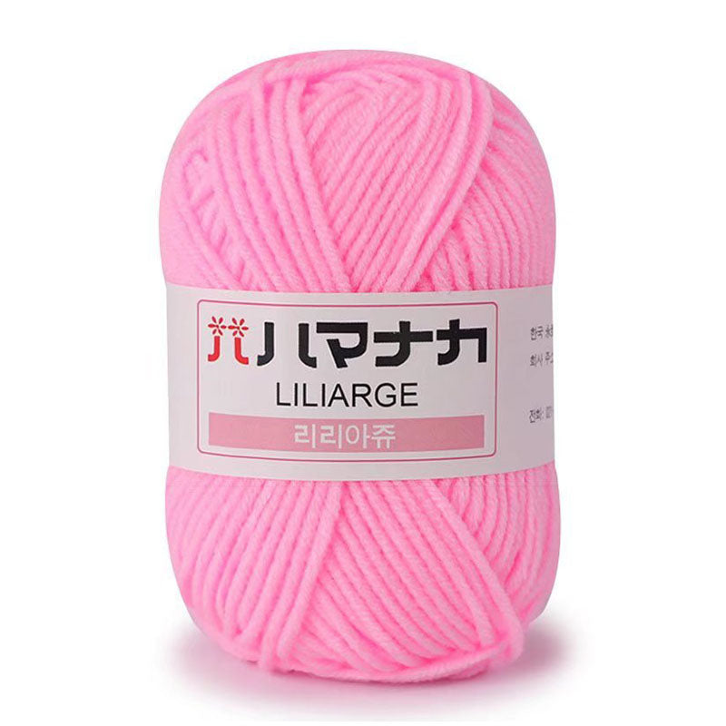 Liliarge DK yarn in bright pink color with label showing product details and weight.